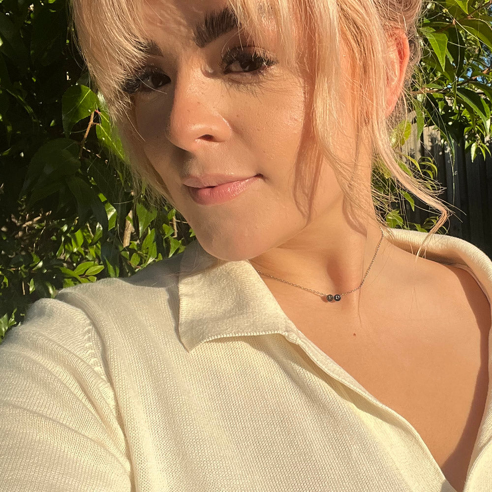 model wearing 2 initial necklace, 2 initial necklace in silver, free engraving, personalised jewellery, 2 different initial engraved on one necklace, waterproof and tarnish resistant, free gift box, 100 day warranty, personalised gift,