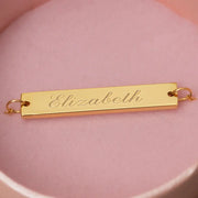 Gold engraved necklace engraved with the name Elizabeth in a script font