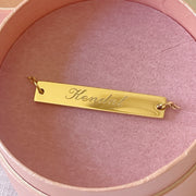 Gold engraved necklace engraved with the name Kendal in a script font