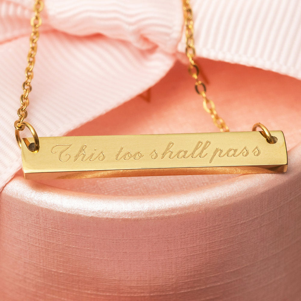 Gold engraved necklace engraved with the phrase This too shall pass