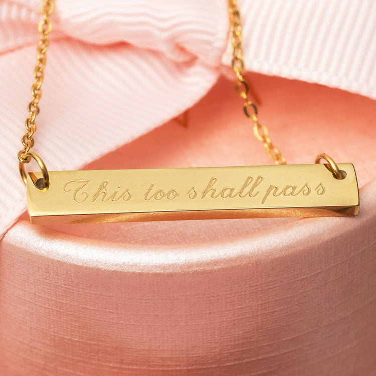 Gold engraved necklace engraved with the phrase This too shall pass