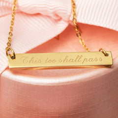 Gold engraved necklace engraved with the phrase This too shall pass