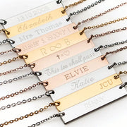 Examples of multiple engraved necklaces in gold and silver, engraved with names, words, dates, co-ordinates, and engraved in different font styles