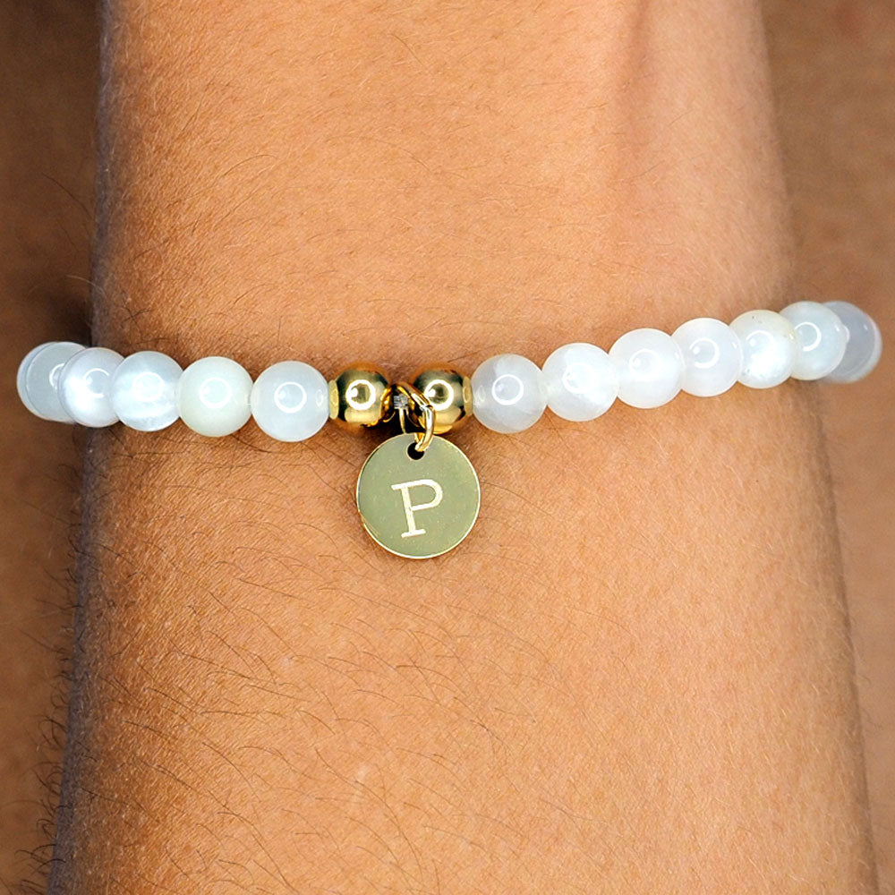 hand made bracelet made from natural moonstone beads and personalised with engraved pendant.