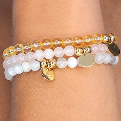 Picture of hand made bracelets made of citrine, rose quartz and moonstone. Personalised with engraving of your choice.